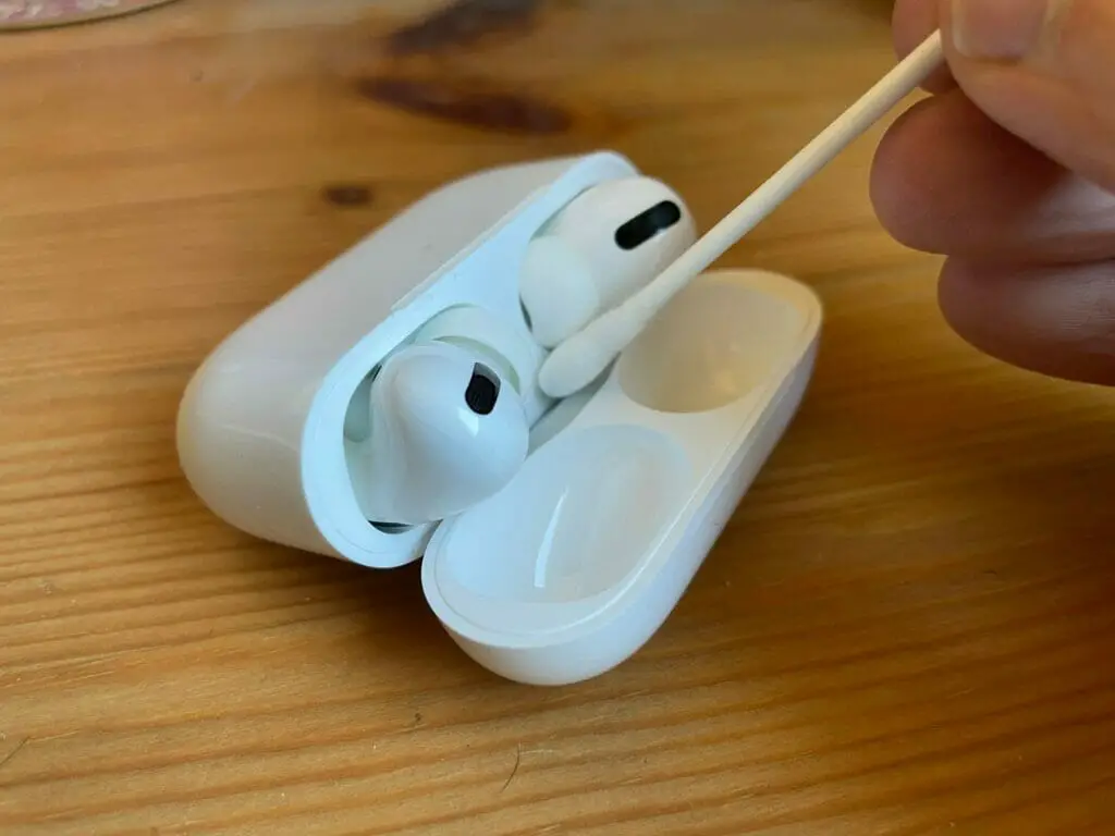 cleaning an Apple AirPods case with ear bud