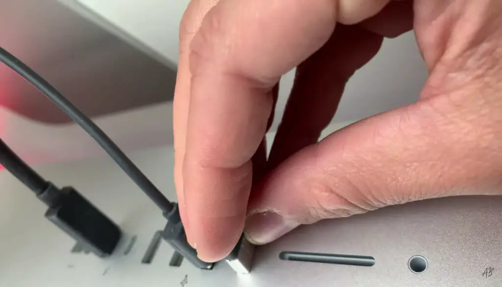 a hand putting in wireless receiver into the laptop USB slot