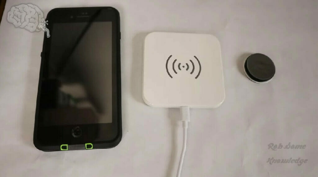 a smartphone, wireless charger and pop socket