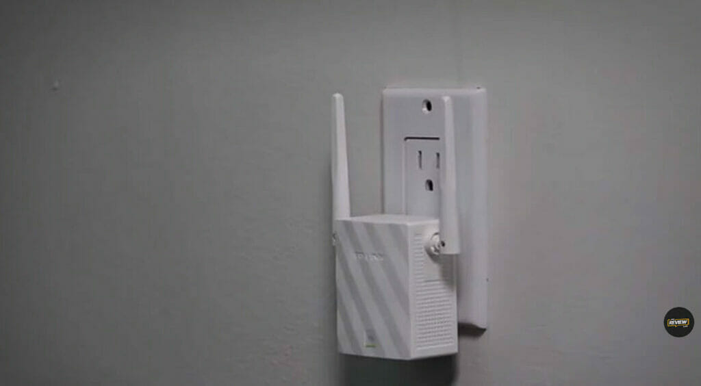 a wifi-extender plugged into a wall outlet