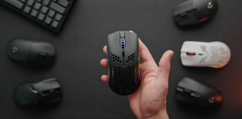 a wireless mouse at the man's right palm with other mouse as background