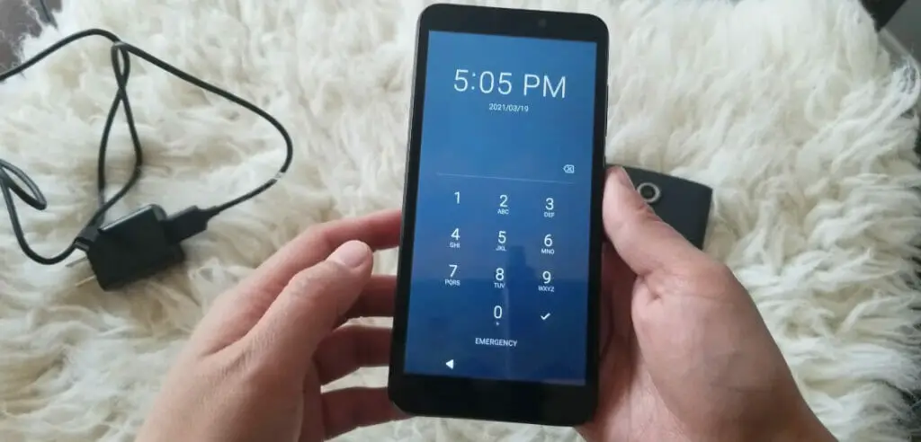 A person unlocking the the phone with the pin code
