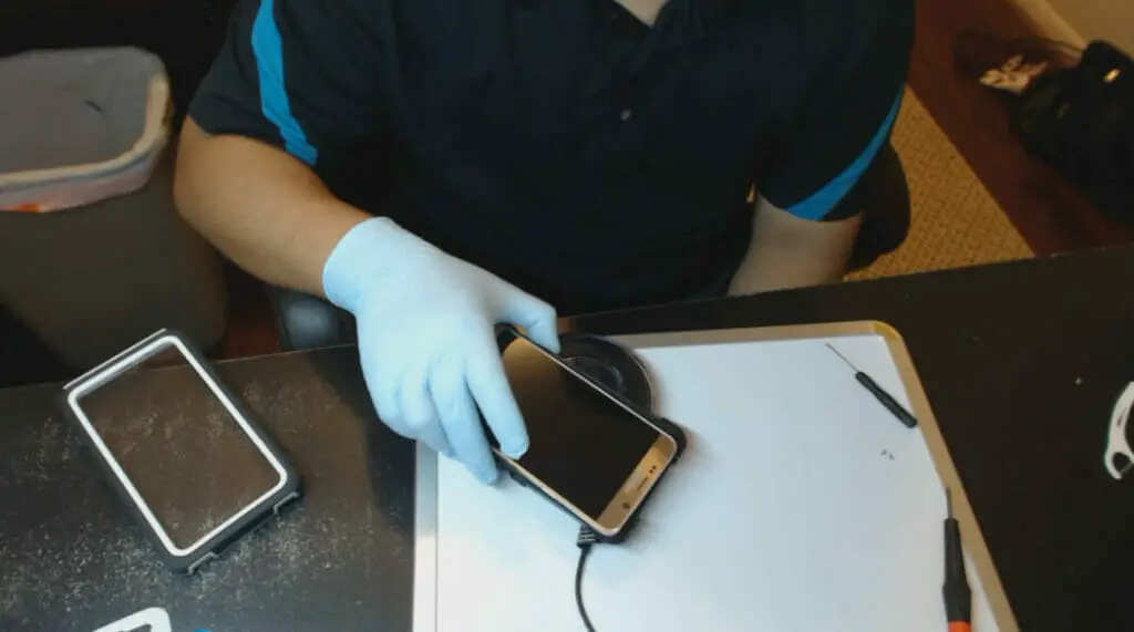 man charging the phone into a samsung wireless charger without the phone's casing