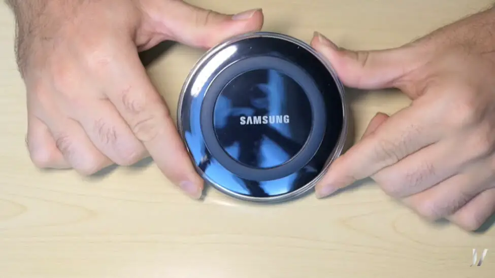 man holding a samsung wireless charger