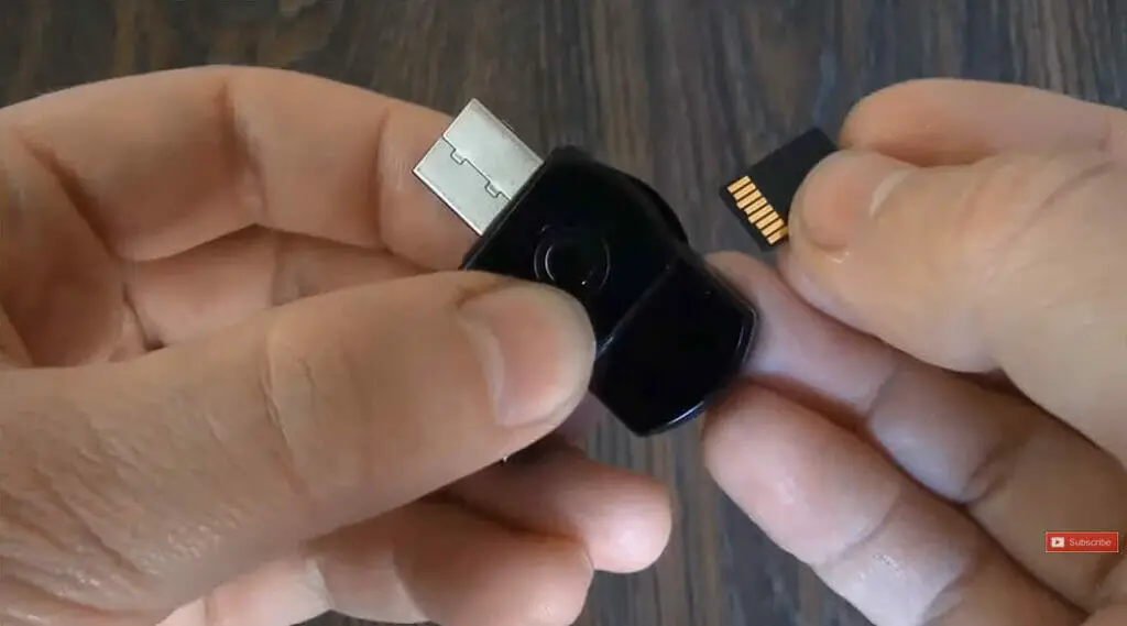 man putting micro-SD on the USB spy camera