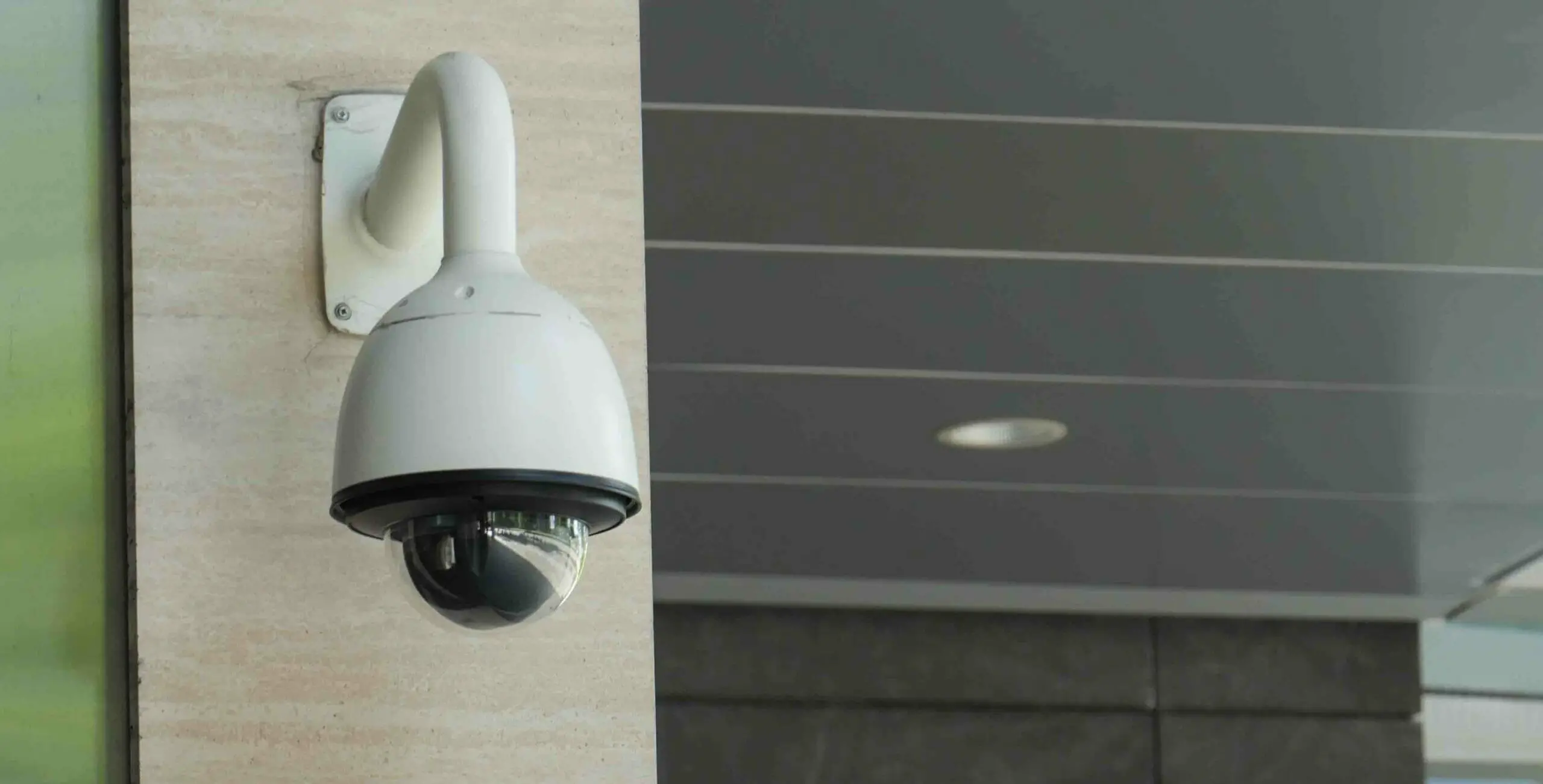 securiy camera mounted at the building or house post