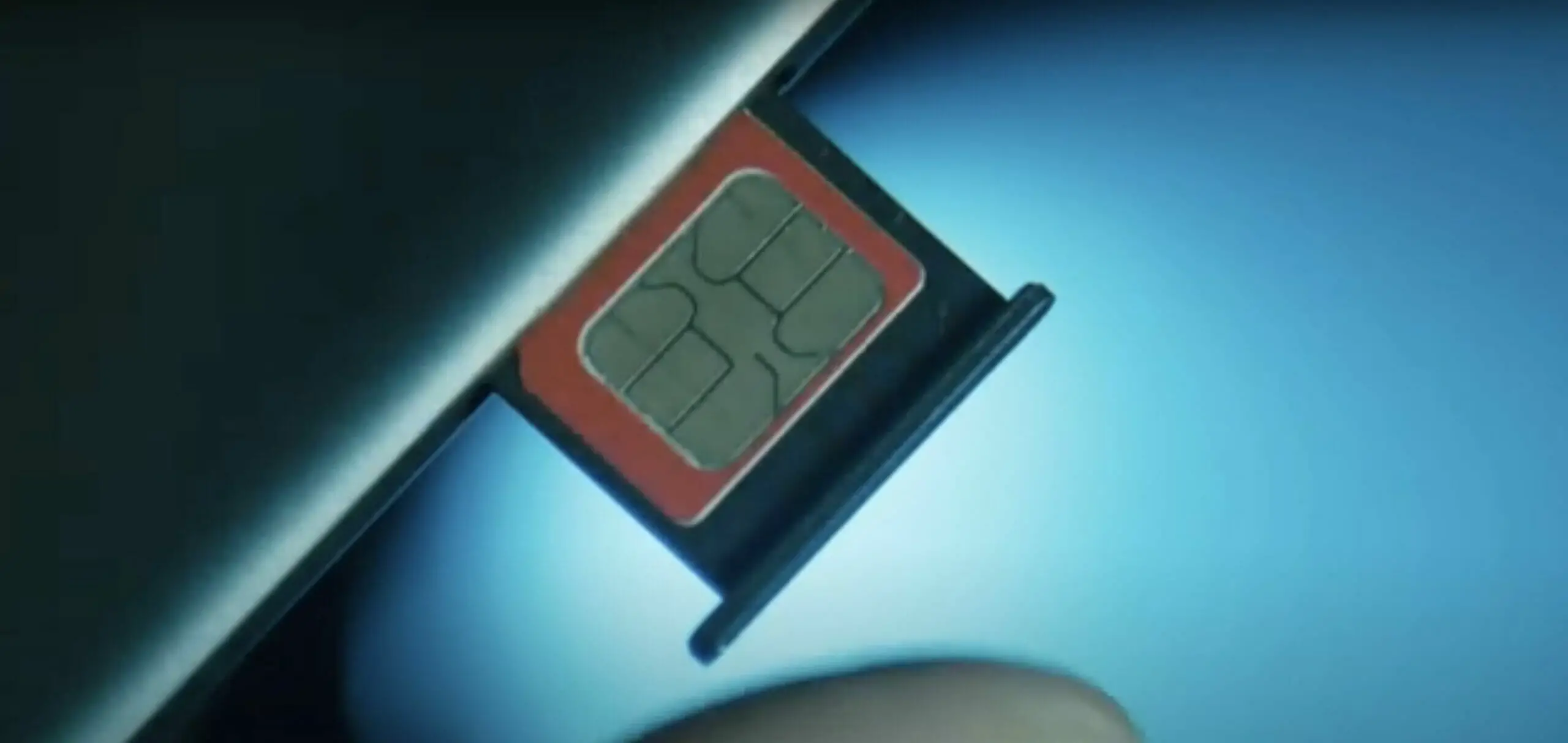 sim card about to be inserted on the phone's sim card slot