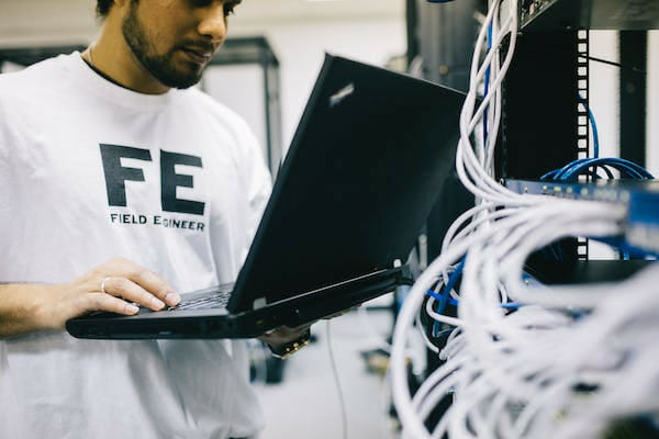 technician on his laptop checking switch internet