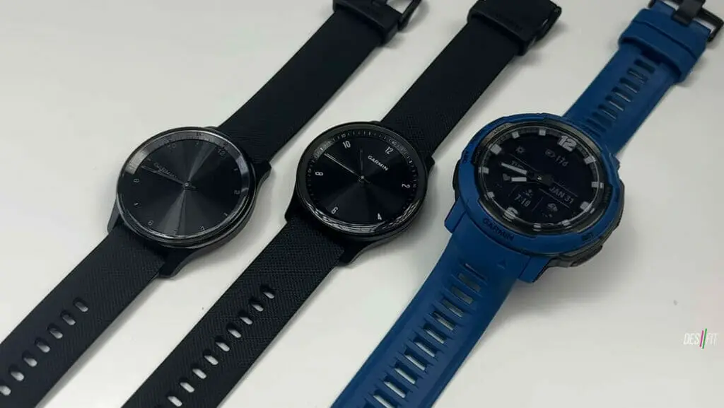 three garmin watches; two blacks, and one blue