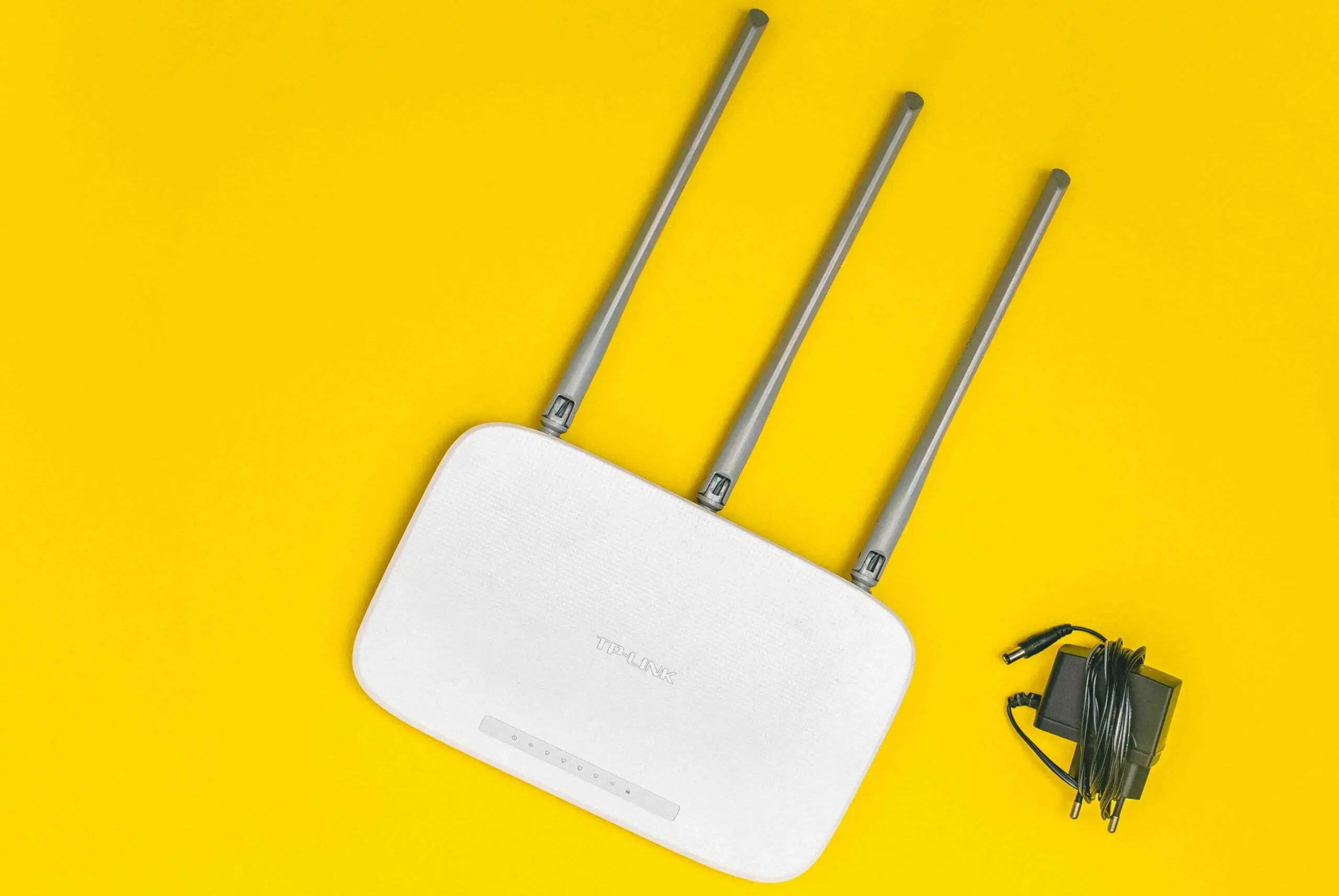 tplink router with cable wire in a yellow background