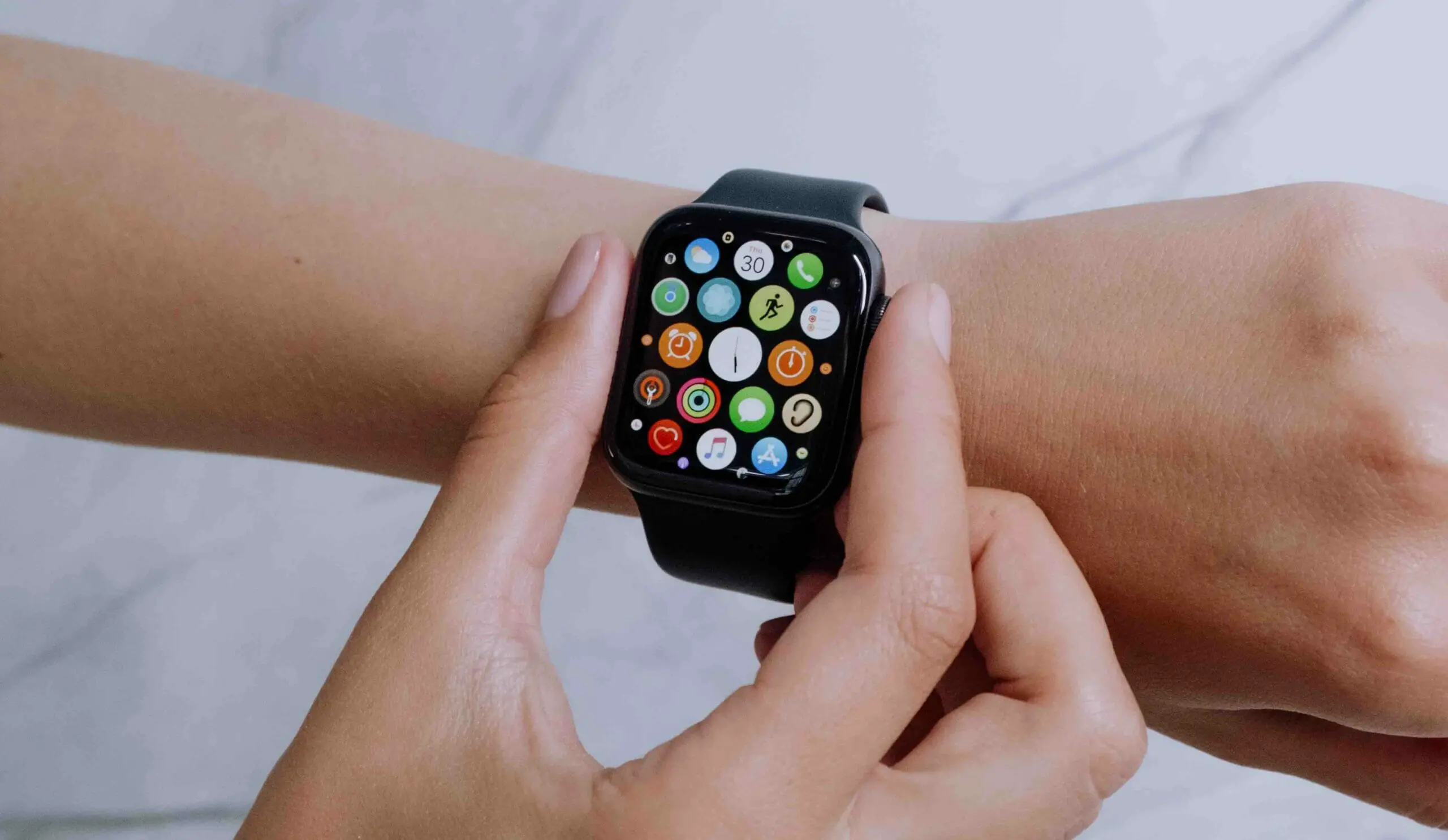 woman checking the apple watch on her wrist