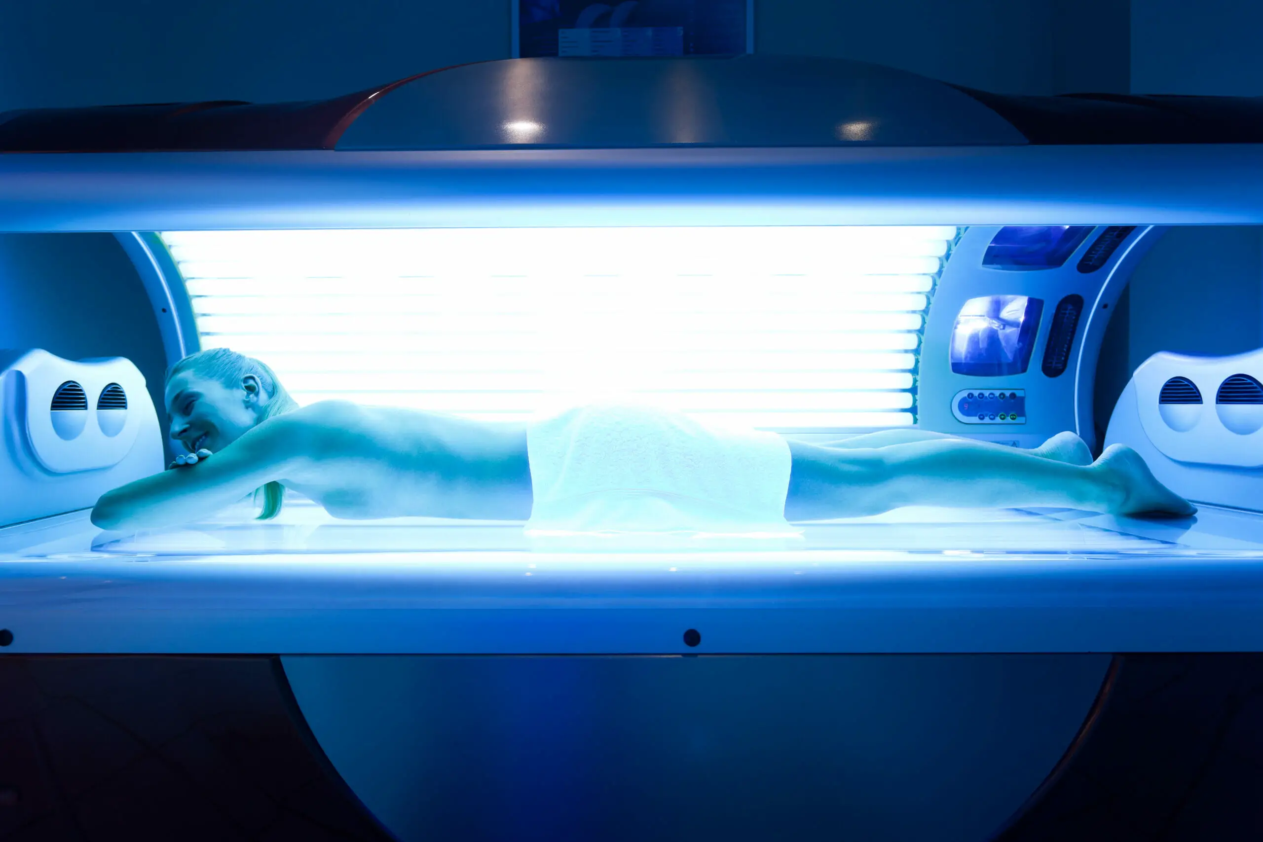 woman on lying on her front in a tanning bed