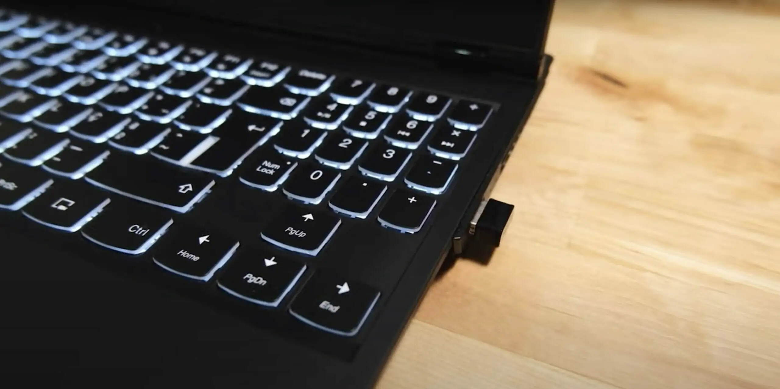 a black keyboard with wireless adapter attached