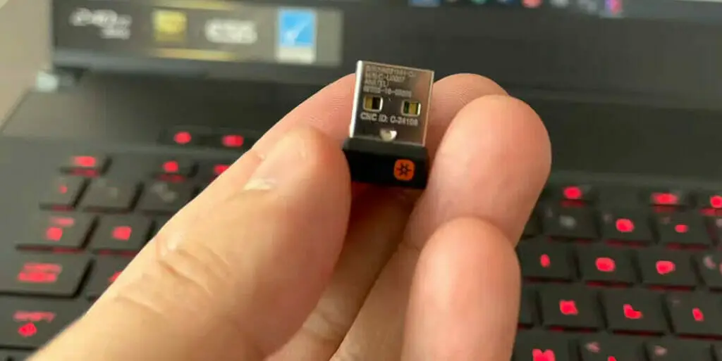 a left hand showing a USB receiver