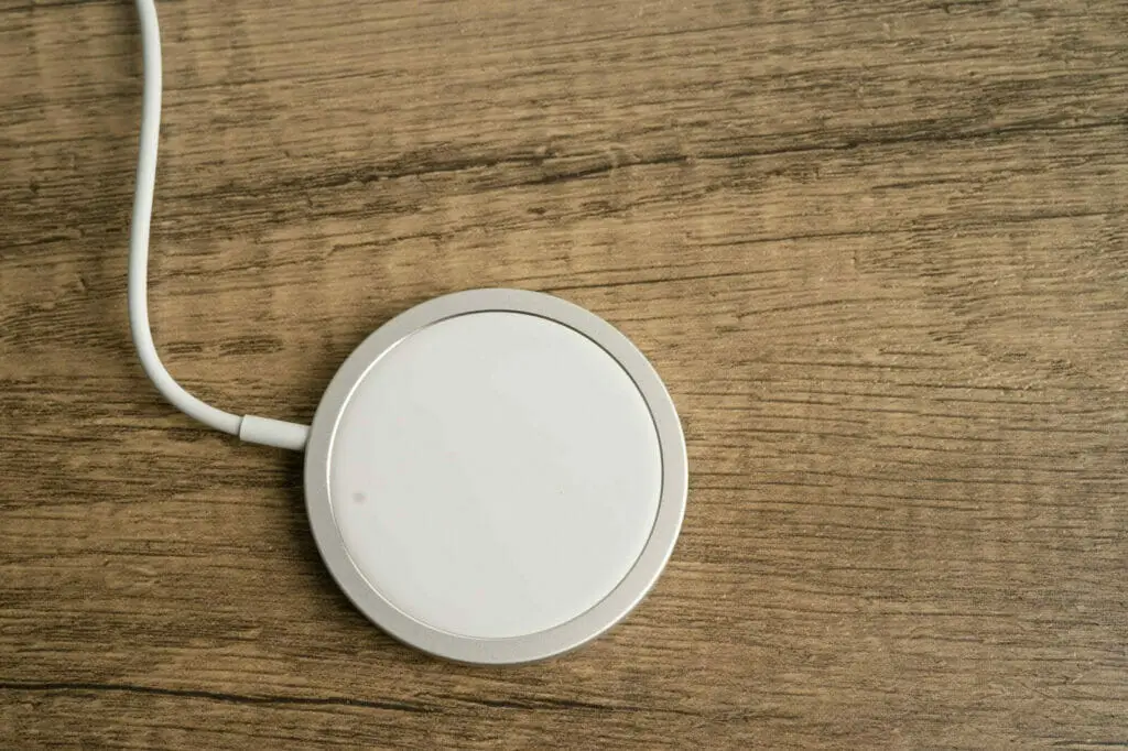 a white wireless charger on a wooden table