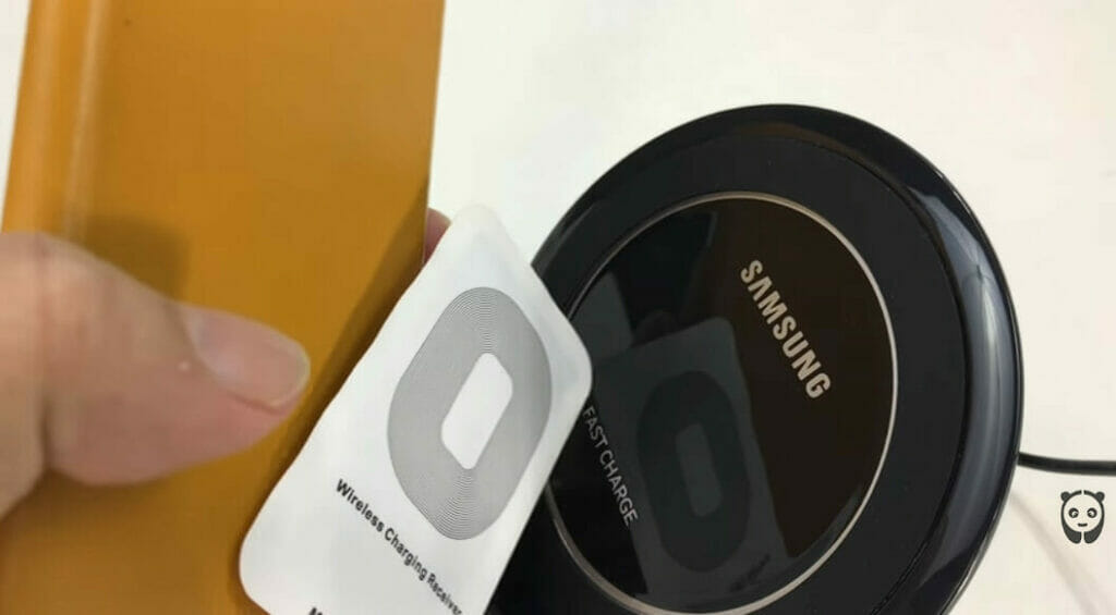 hand holding a samsung wireless charging adapter