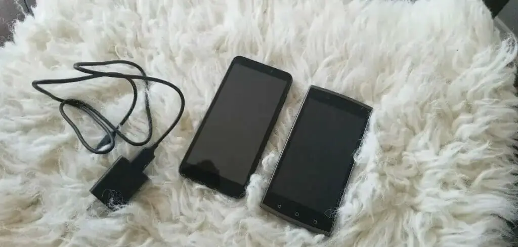 Two phones laid on the bed