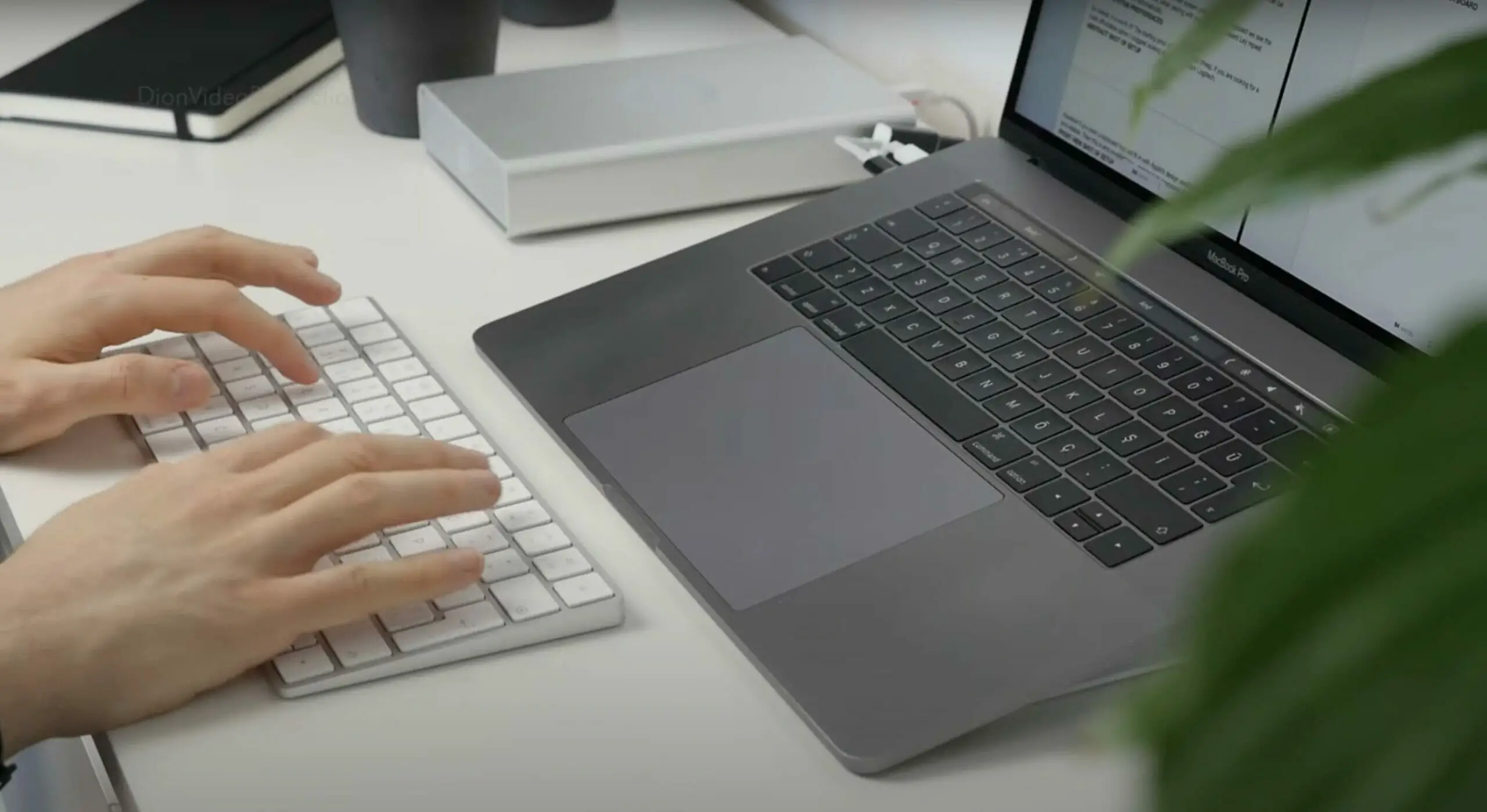 man typing on his mac wireless keyboard