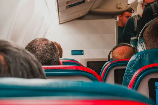 view of the airplane seats with people