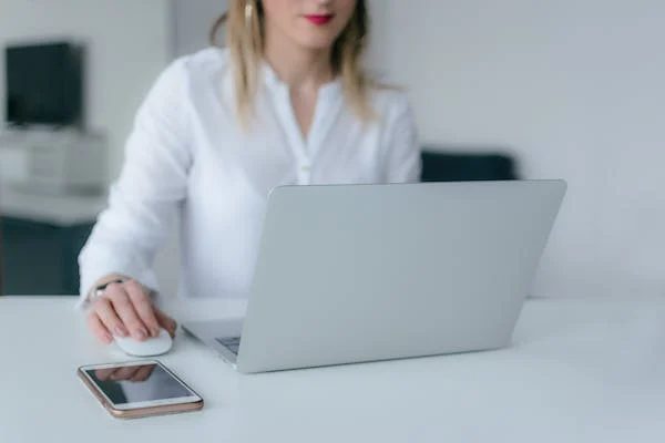 woman working at her computer on a conference desk