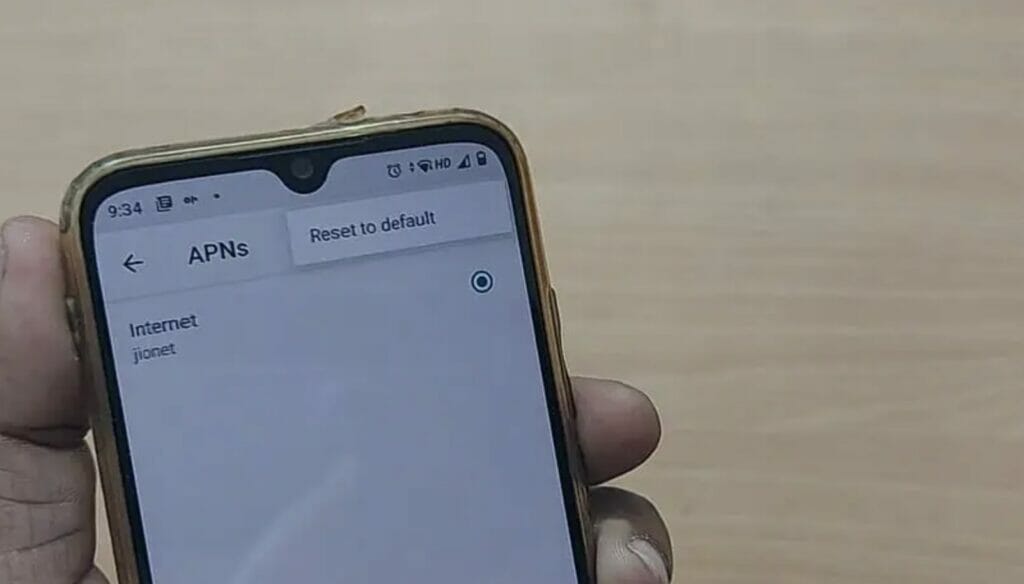 A person holding the phone showing the APN list