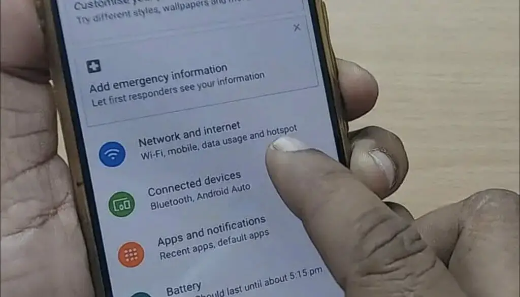 A person tapping the connected devices setting on the phone