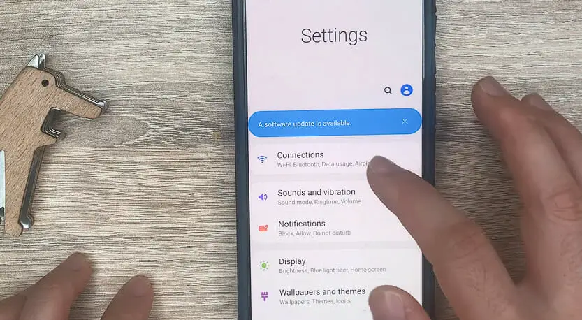 a finger tapping on the Connections option on the setting of an samsung phone