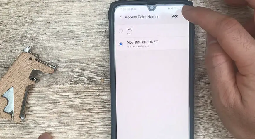 a finger tapping the ADD button for APN's phone setting