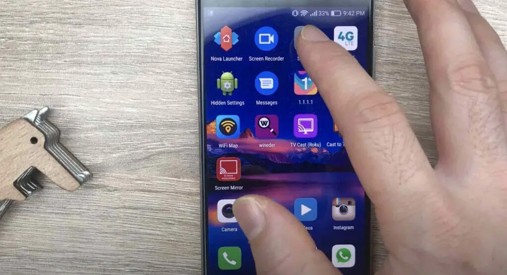 A hand tapping the setting icon on a phone
