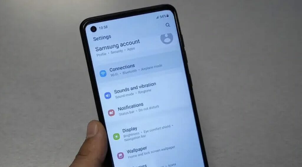A person holding a samsung phone navigating to connections setting