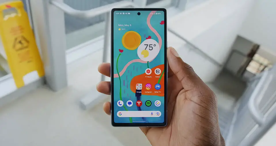 A person is holding up a Samsung Galaxy S10e
