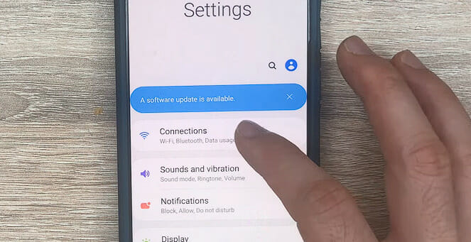 finger tapping on the Connections setting on a phone