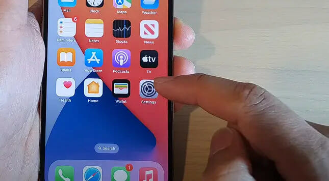 a person tapping on the iphone's setting icon 