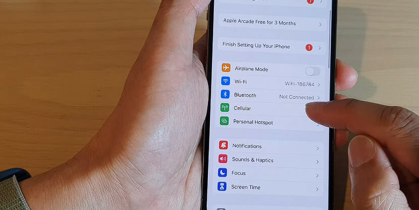 man enabling cellular option on an iphone setting