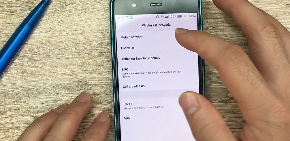 man tapping the Mobile network option on his phone setting