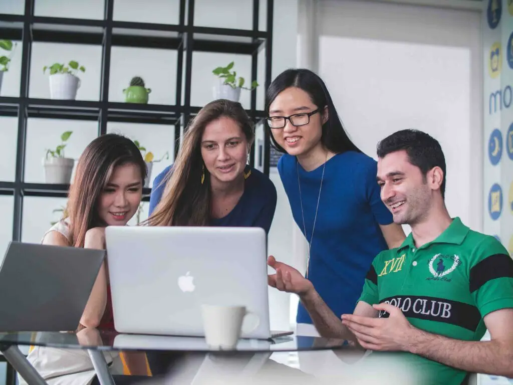 A group of people discussing at the office