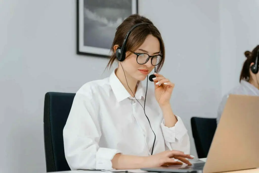 Two women in headsets working in an office