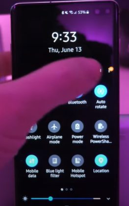 A person tapping the Setting icon on a Samsung phone
