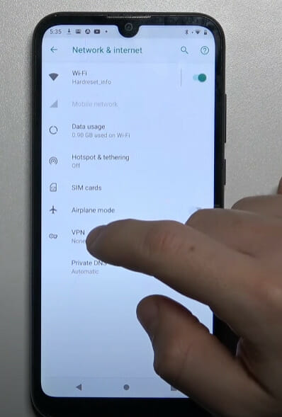 A person tapping on VPN setting on the phone