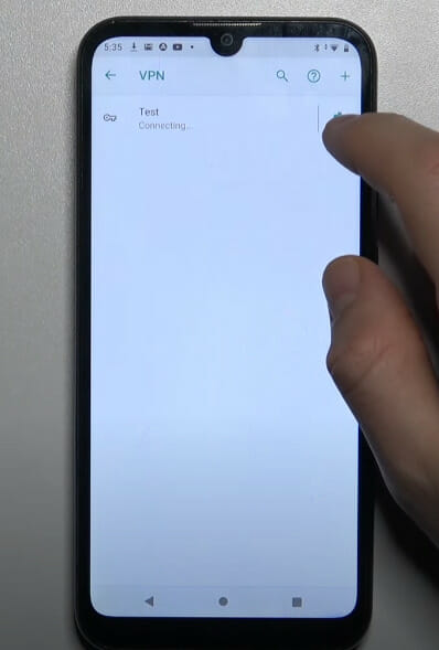 A person editing the VPN setting on the phone