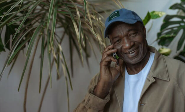 An older man talking on his cell phone