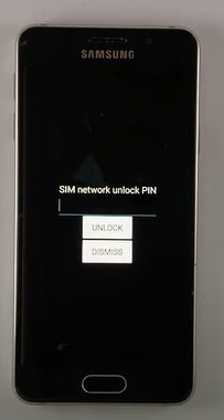 A Samsung phone with text "Sim network unlock PIN" text displayed in it