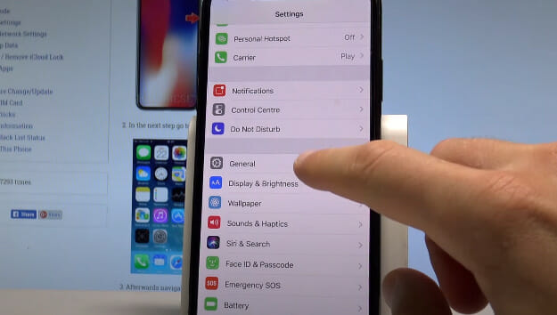 A person is navigating to iPhone's setting list and tapping on a General menu