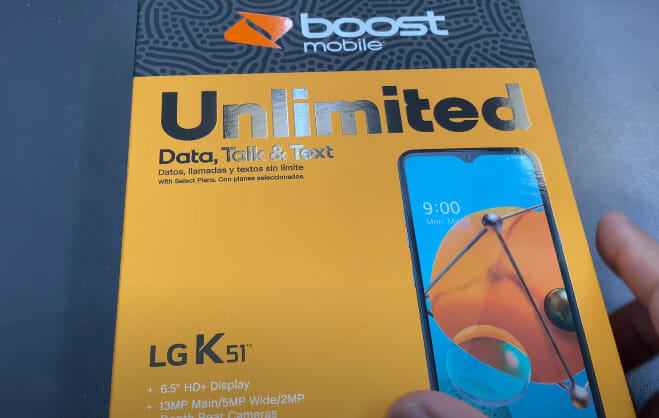 A person unboxing the Boost Mobile LG K51