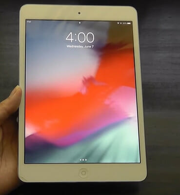 A person is holding up an ipad mini