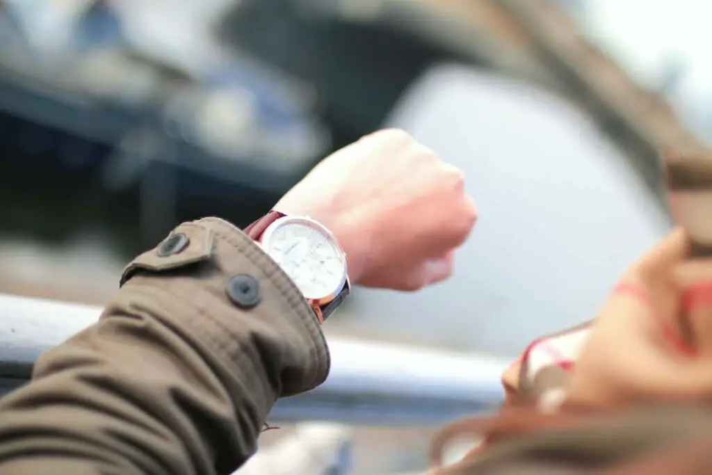 A person checking the wrist watch