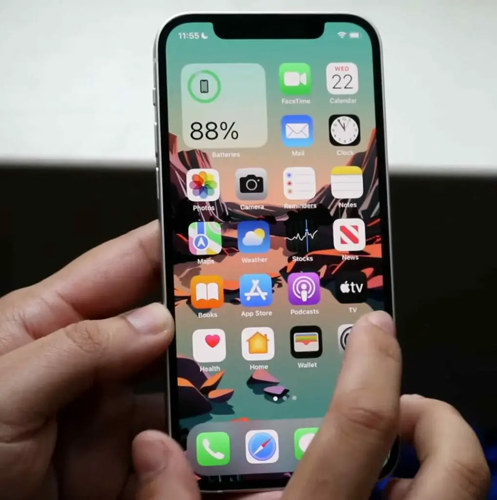 A person is holding an iPhone X in their hand