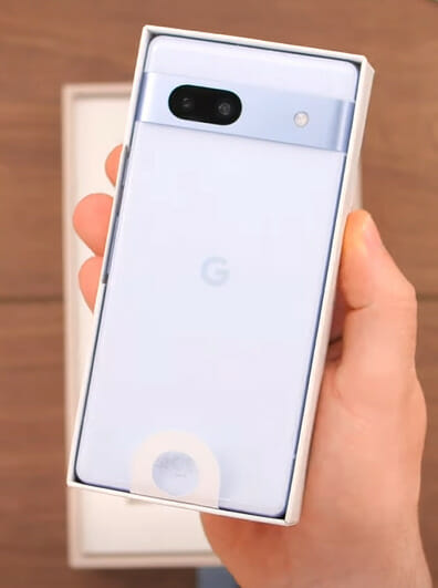 A person holding a google pixel phone in its box