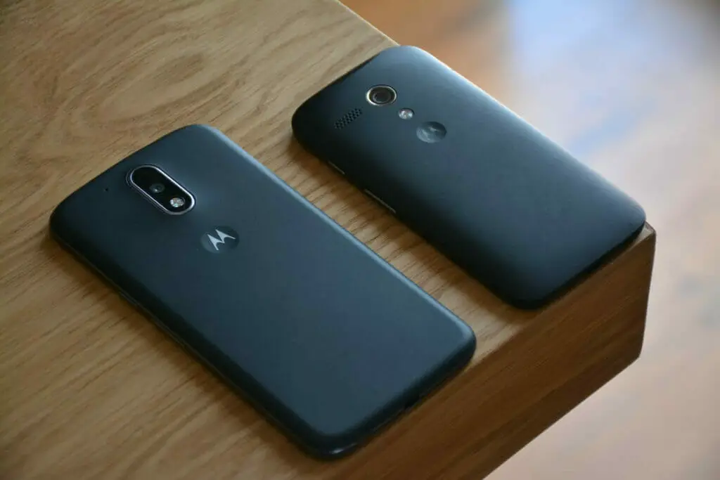 Two motorola moto g smartphones on a wooden table