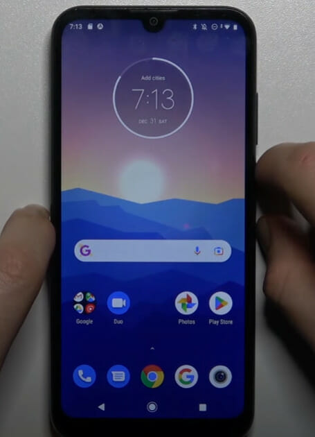 The Motorola Moto G7 is being held up by a person
